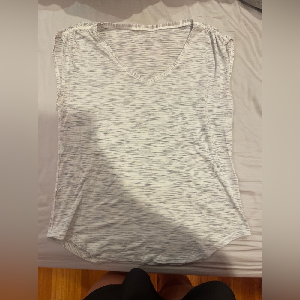 size six lululemon top. sleeveless in the discontinued heather pattern